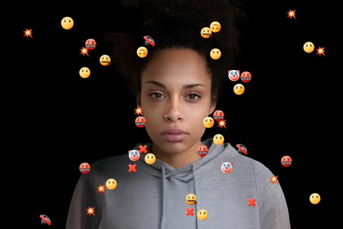 16 Days of Activism 2025 campaign image. In the photo a woman looks at the camera surrounded by hateful emojis. Photo: UN Women. 
