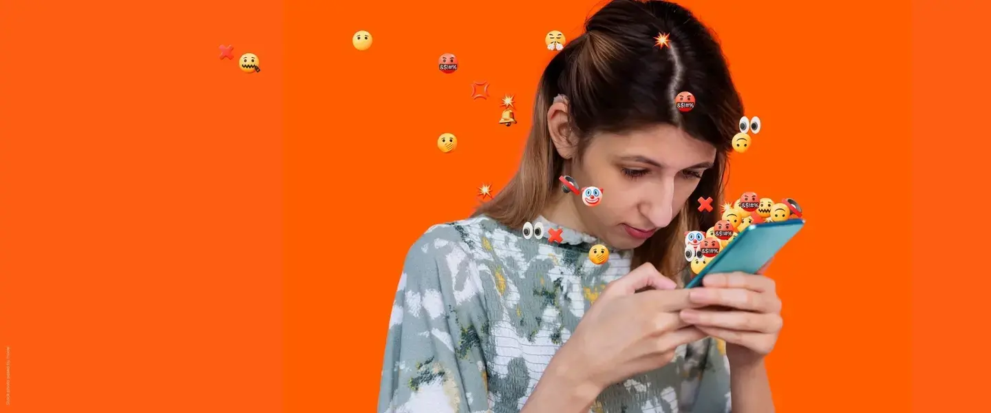 A woman looks at her phone concerned. AI powered abuse is threatening women and girls everywhere. There is no excuse for online abuse. Photo: UN Women